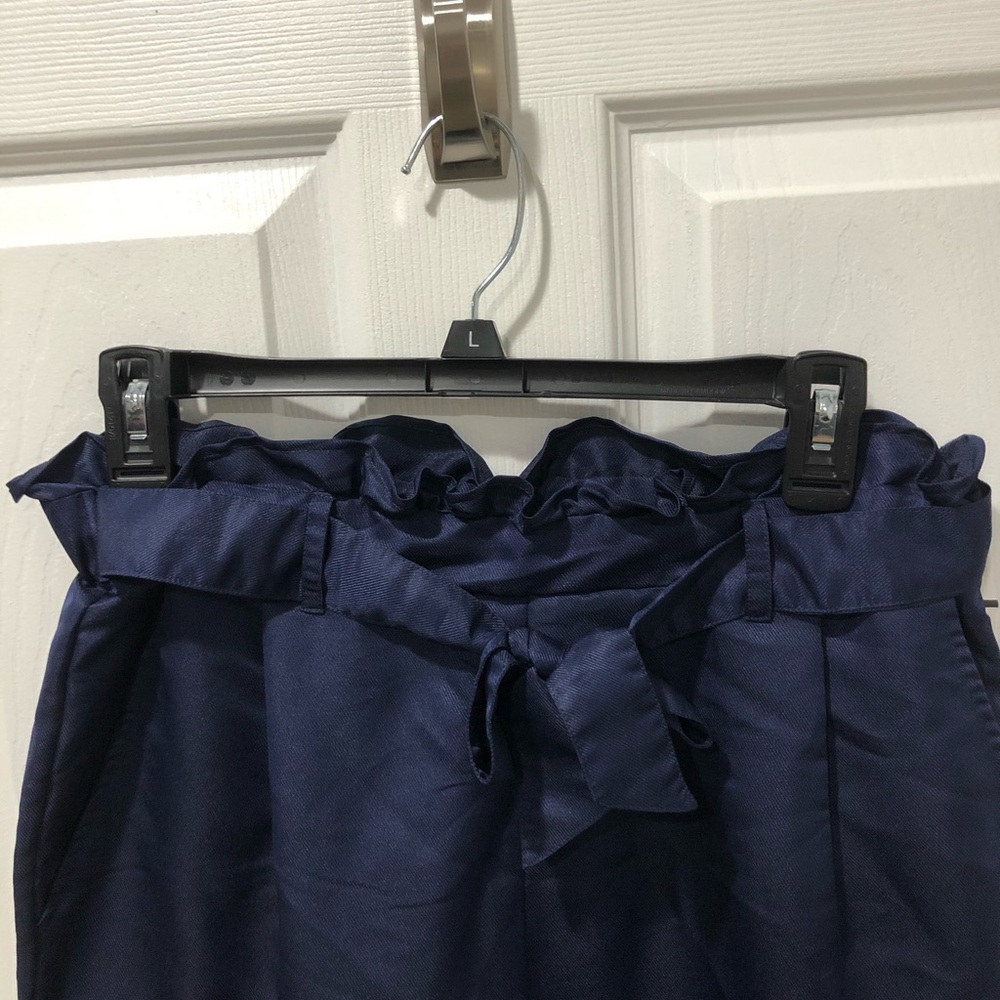 Navy stretch dress pants with ruffle waistline